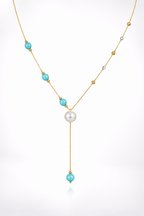 An elegant gold necklace designed with refined detailing and soft color accents.
