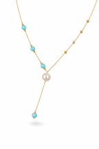 An elegant gold necklace designed with refined detailing and soft color accents.
