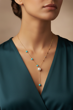 An elegant gold necklace designed with refined detailing and soft color accents.
